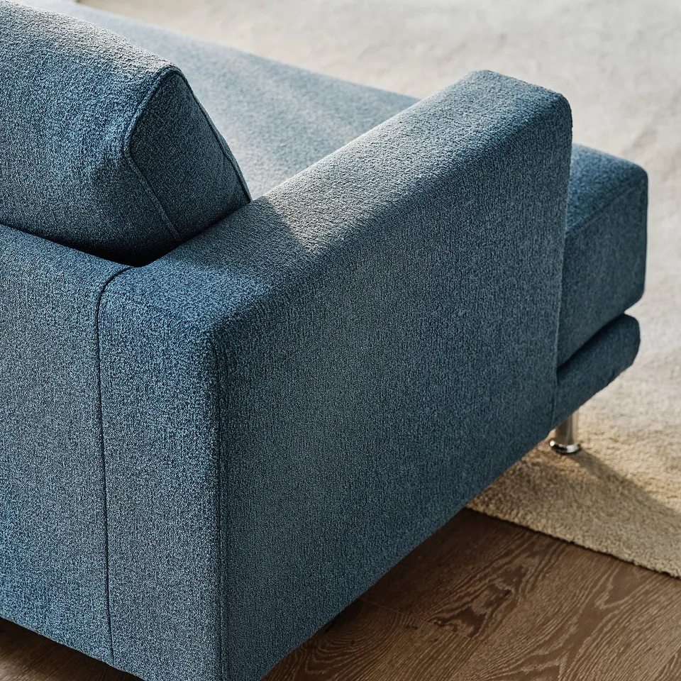 Blue sofas plush cushions & sleek design detail, showcasing quality comfort.