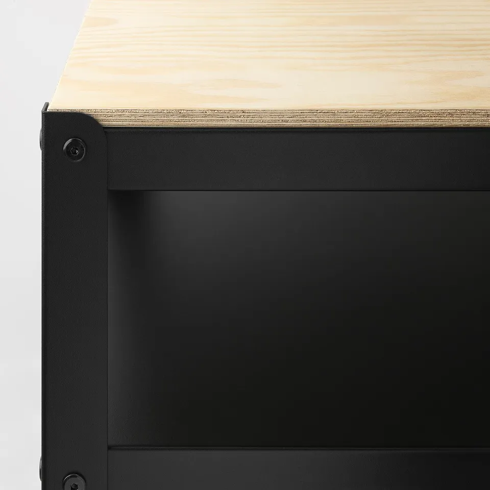 Heavy-duty workbench with sturdy metal frame and wooden top, designed for durability.