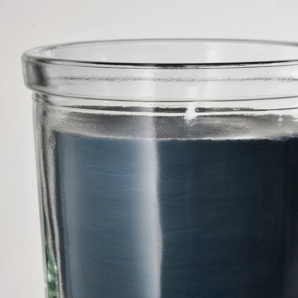 Glass candle holder with glossy finish and centred wick.