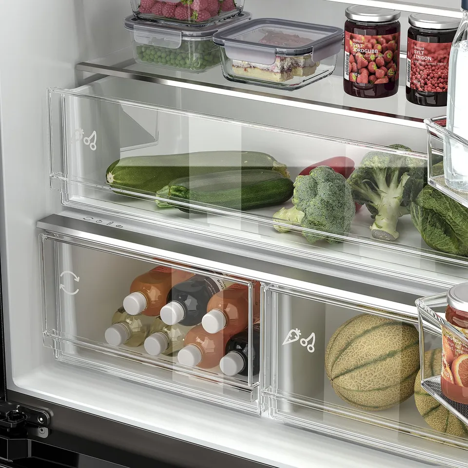Stainless-steel fridge with adjustable shelves and organised veggie drawers.