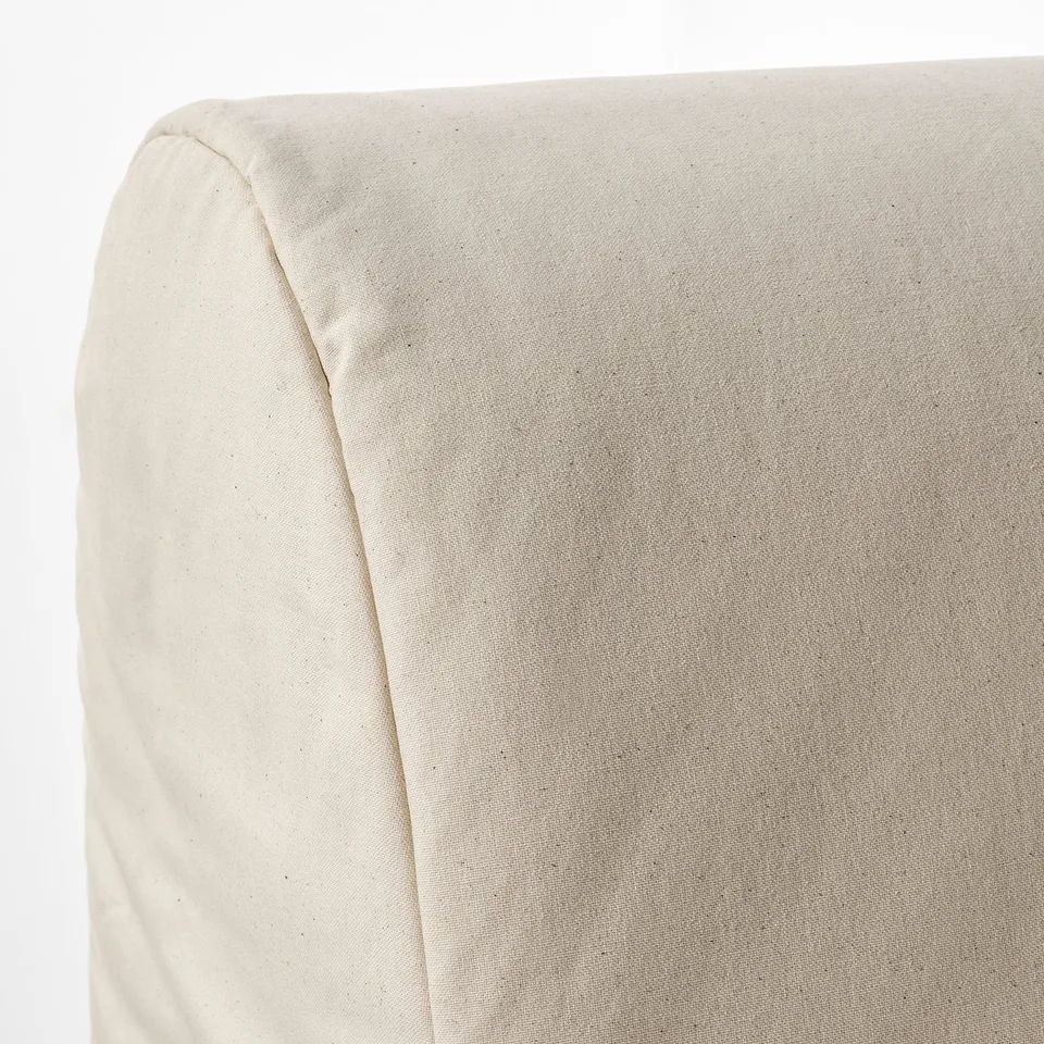 Close-up of a beige sofas plush, soft fabric showcasing its smooth texture and clean stitching, highlighting comfort and quality.