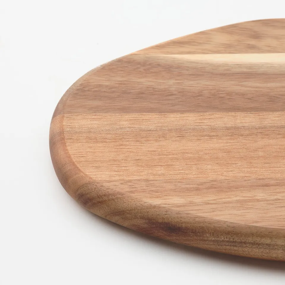 Smooth, high-quality acacia wood cutting board with visible grain.