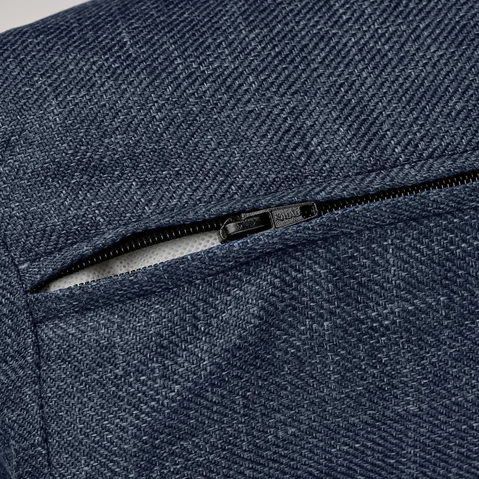 Dark blue woven fabric sofa-bed zip detail, showcasing quality texture and craftsmanship.