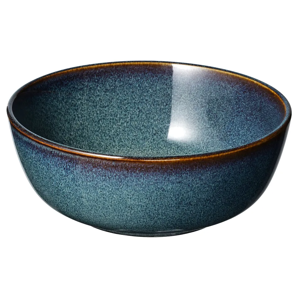 Ocean-blue GLADELIG bowl with golden rim, round shape, crafted look, reactive glaze, unique design.