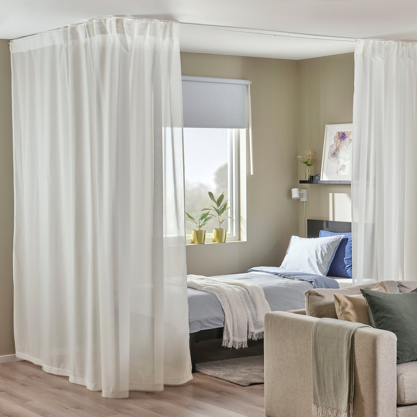 Modern bedroom with sheer curtains, bed, and potted plant.