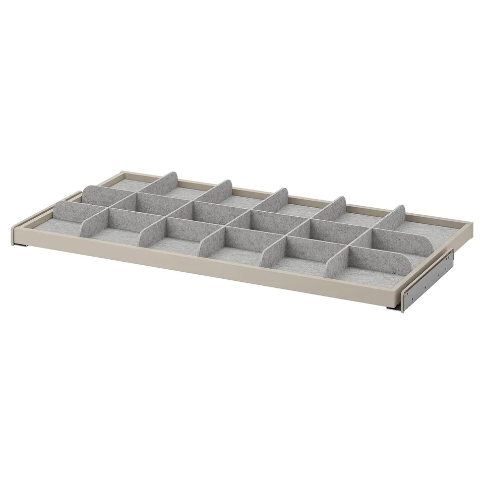 A white KOMPLEMENT drawer organiser with fabric dividers for tidy storage.