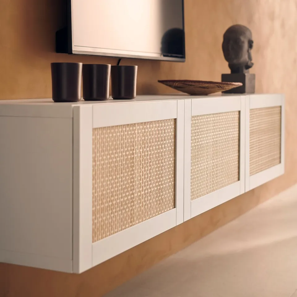 White woven sideboard with dark vases and wooden decor.