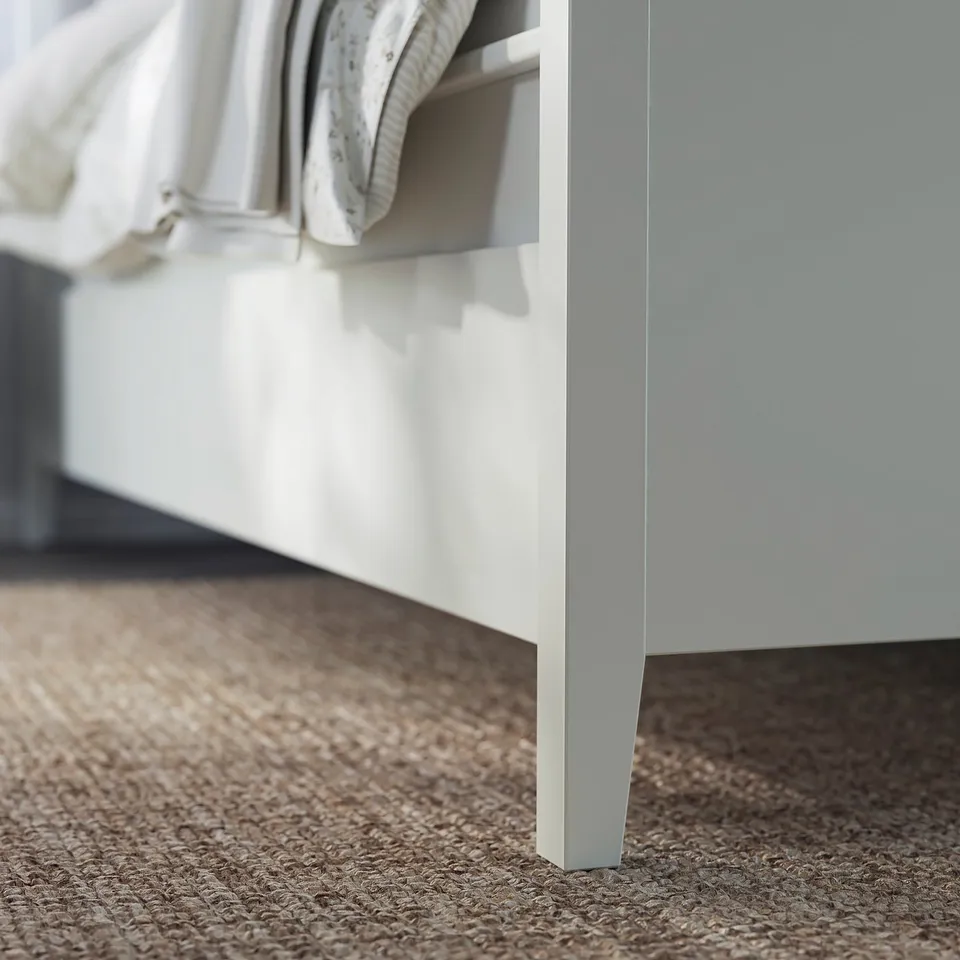 IDANÄS white bed frame with drawer, textured beige rug.