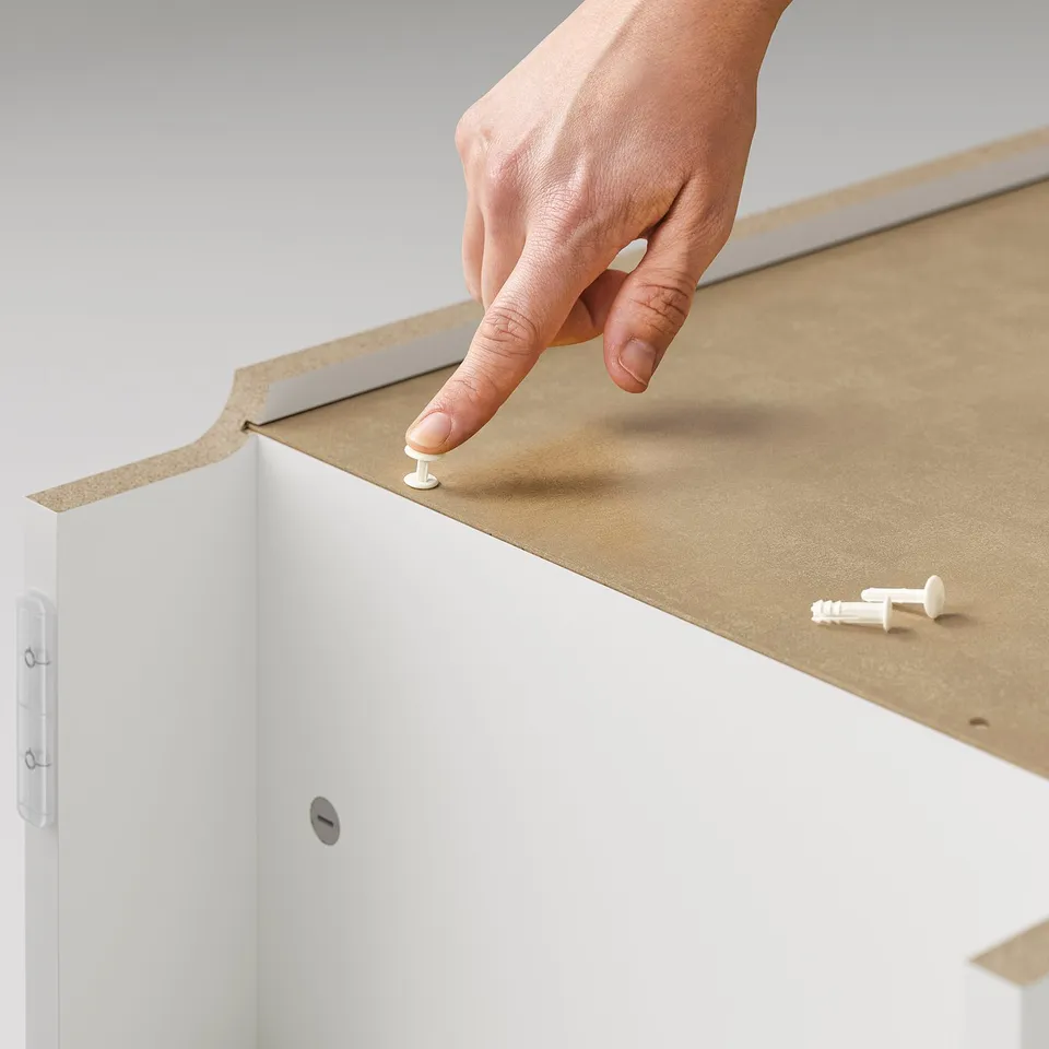 Assembling white BILLY furniture.