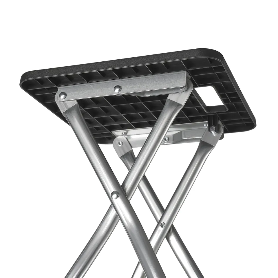 Foldable metal stool with black plastic seat, shown in half-folded position, highlighting robust construction and efficient storage design.
