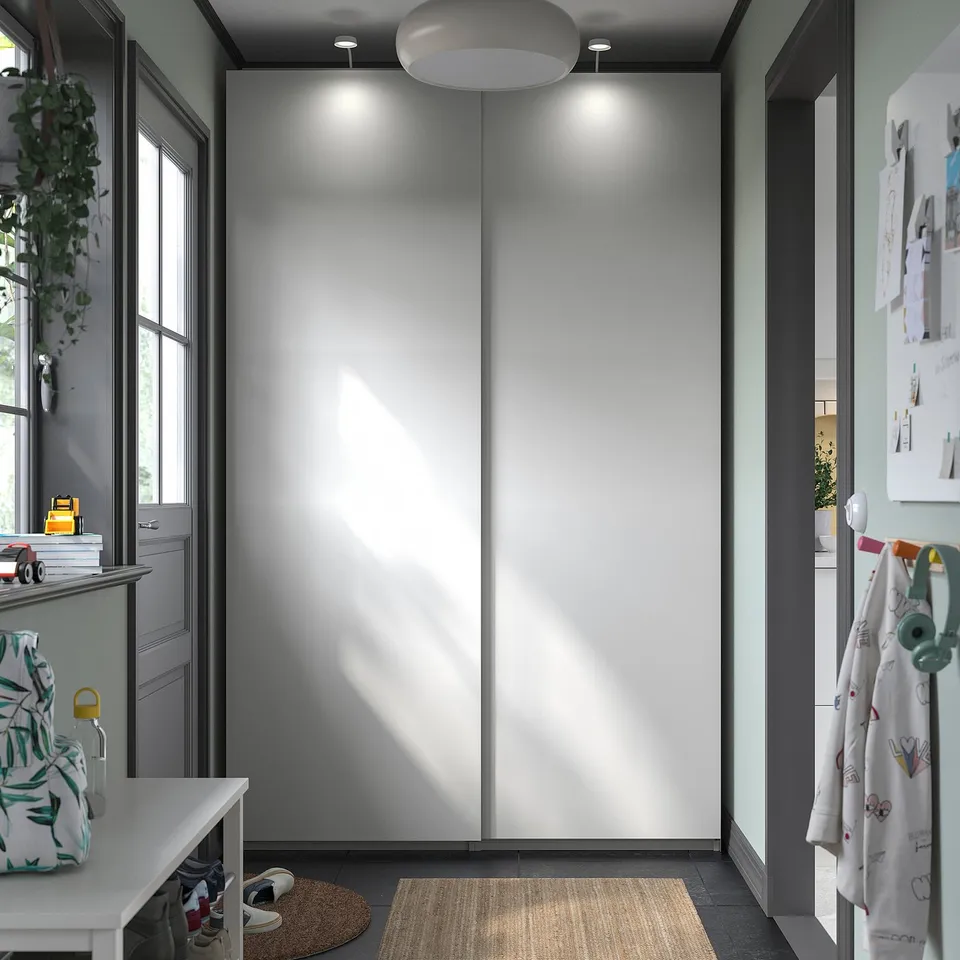 Minimalist white dresser, recessed lights, storage.