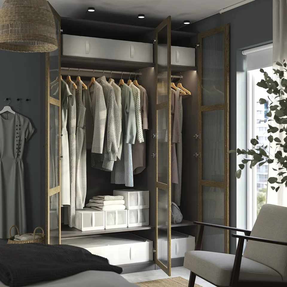 Modern walk-in closet with mirrored doors, clothes, shelves, storage, adjustable feet, and lighting.