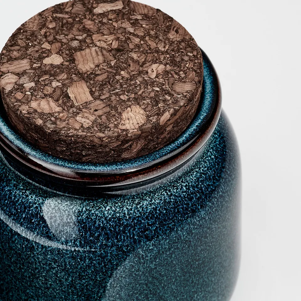 Dark green glazed stoneware jar with tight-fitting cork lid, showcasing high-quality craftsmanship.
