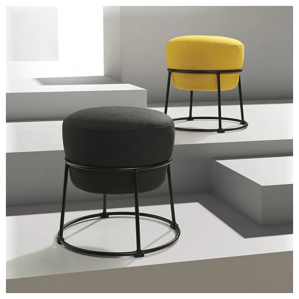 Two modern stools, one black, one yellow; round cushions, metal frames; minimalist design.