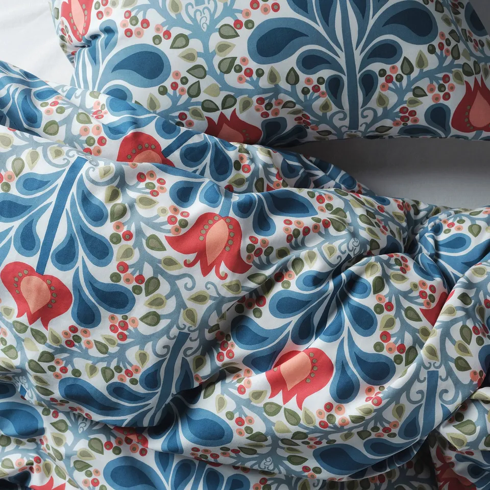 A duvet cover set with intricate, colourful folk art print. The fabric looks soft and durable, perfect for bedding.