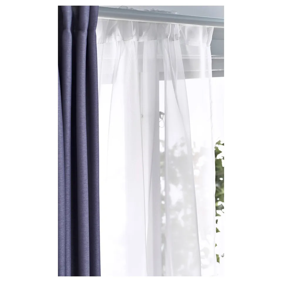 Sheer curtains on rod, allowing light in, used for privacy.