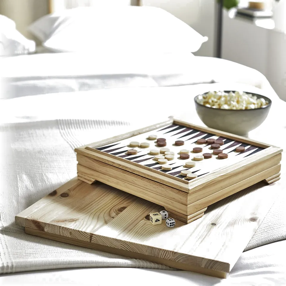 Wooden game board on bed with pizza; white bedding, light wood tray.