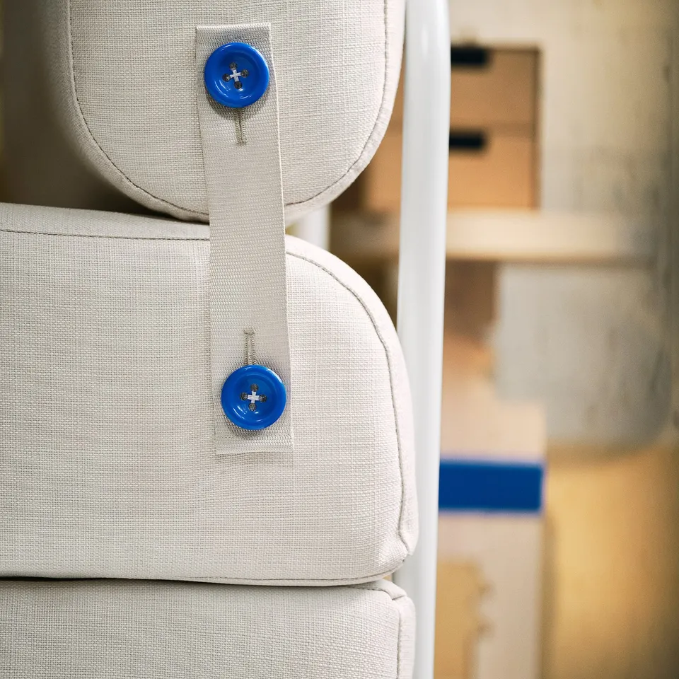 Stacked beige chair beds, each secured with blue buttons, neatly arranged.
