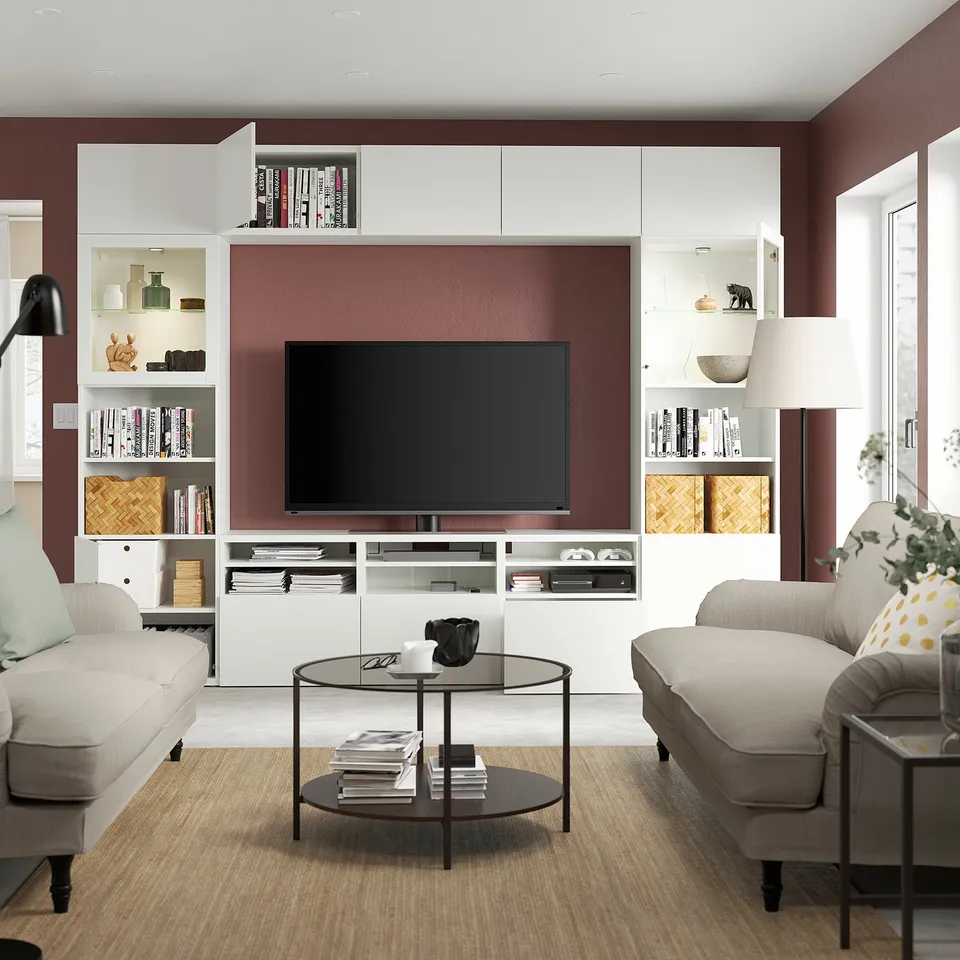 Modern living room with a BESTÅ tv storage unit. Functions include adjustable shelves, cable management, and soft-closing drawers.