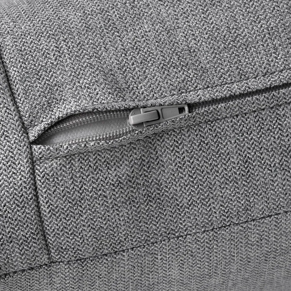 Close-up of a grey fabric zip on a high-quality sofa, showing durability and easy-to-use design.