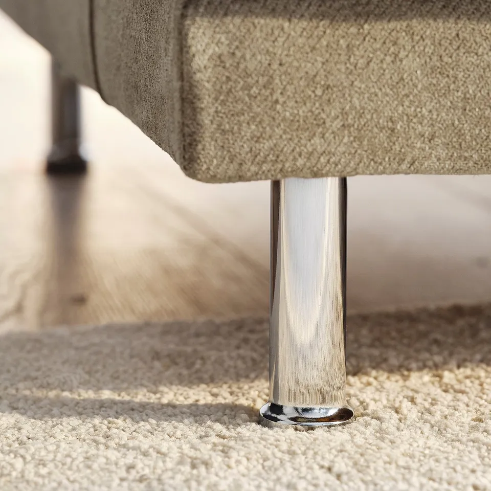 Modern sofa leg detail, polished chrome finish, showcasing sleek design and quality craftsmanship.
