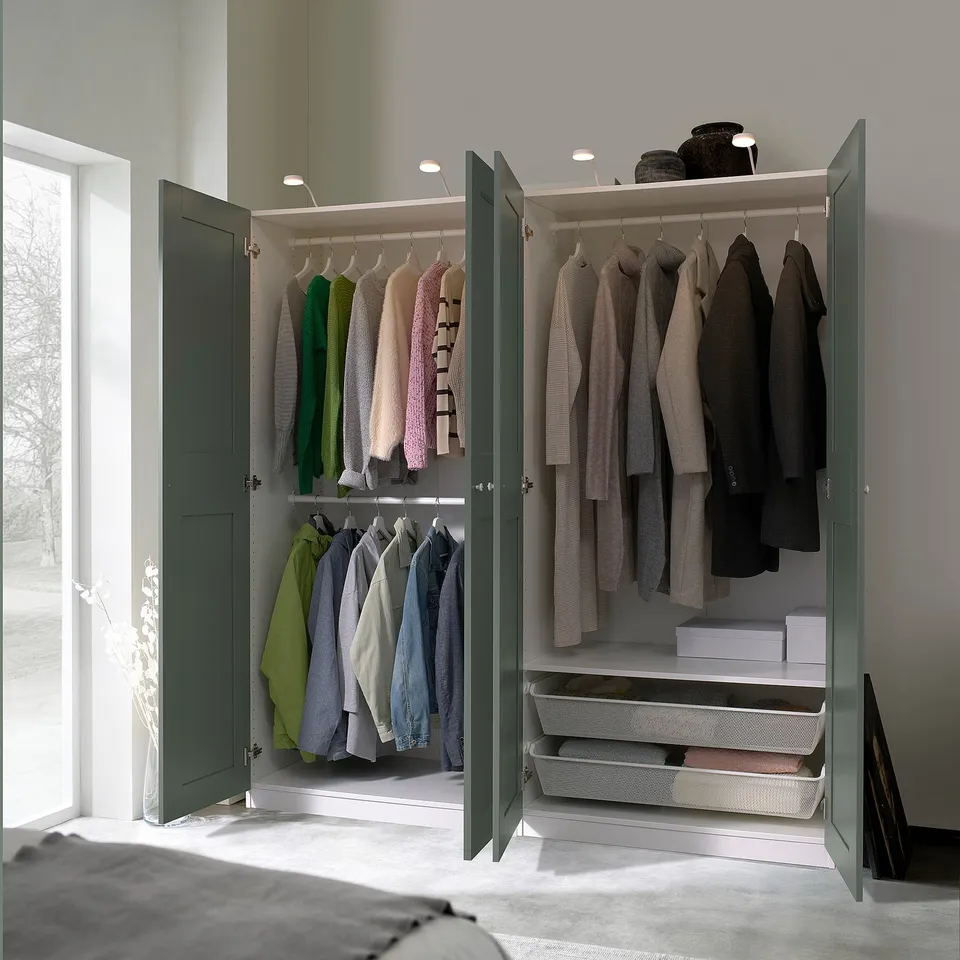 Green PAX wardrobe with clothes and storage baskets.