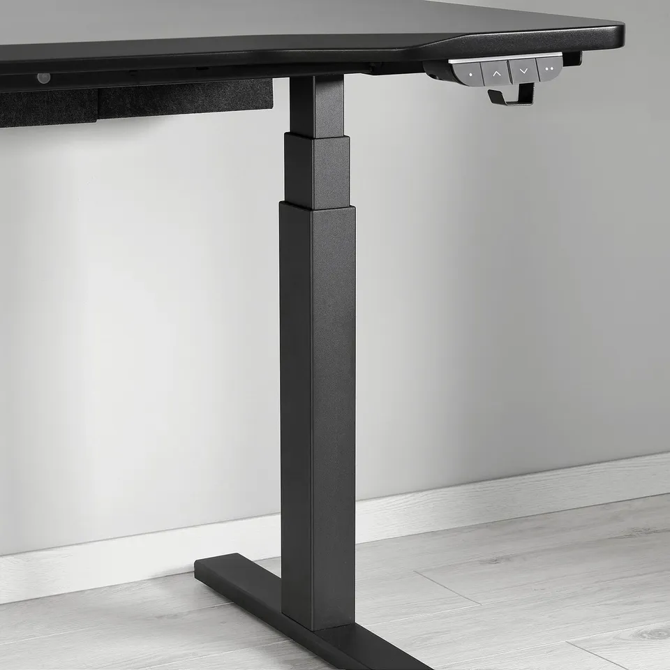 Small section of a modern black standing desk with sleek controls and sturdy legs.