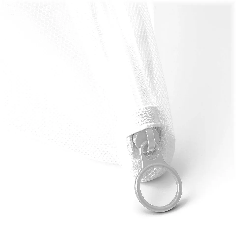 Close-up of durable mesh washing bag with zip ring pull for easy use.