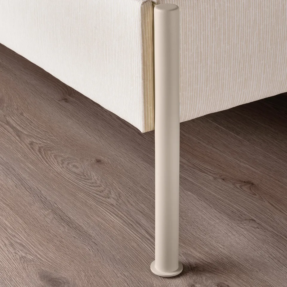 A modern bed frame with clean lines and beige upholstery. Sleek metal legs and a cushioned headboard.