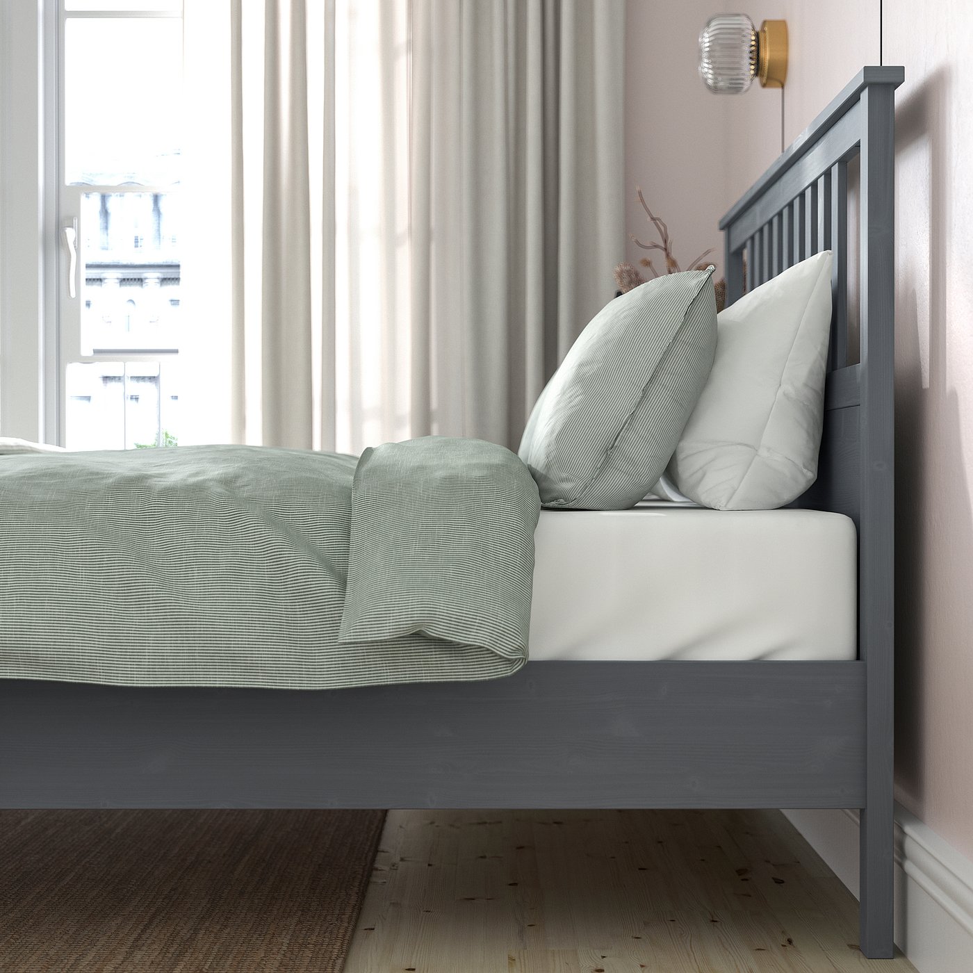Modern solid wood bed with adjustable sides, white and grey bedding, by large window.