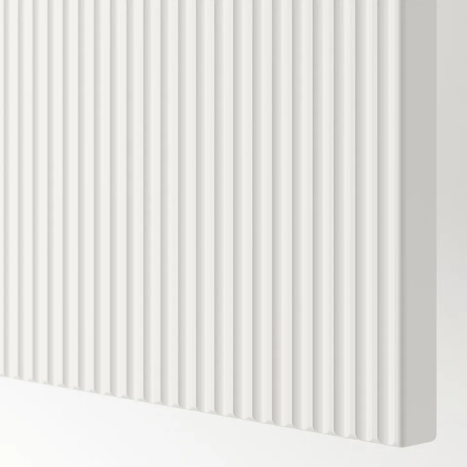 White fluted textured panel, smooth & modern, part of a drawer or cabinet front.