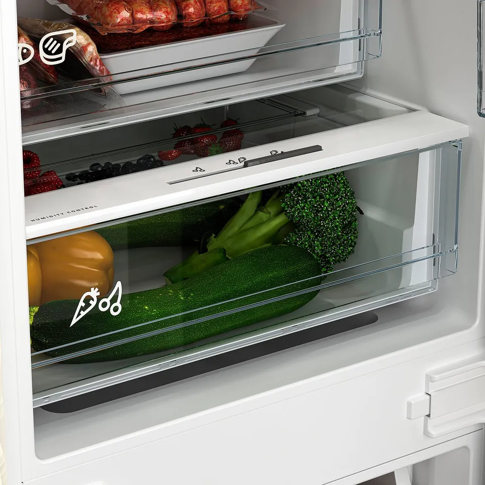Refrigerator with humidity control drawer storing fresh vegetables and fruits.