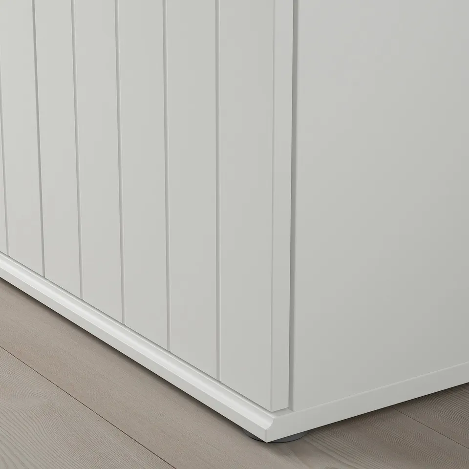 Close-up of SKRUVBY furniture corner, showcasing smooth, durable white finish and clean, detailed edges on wooden flooring.