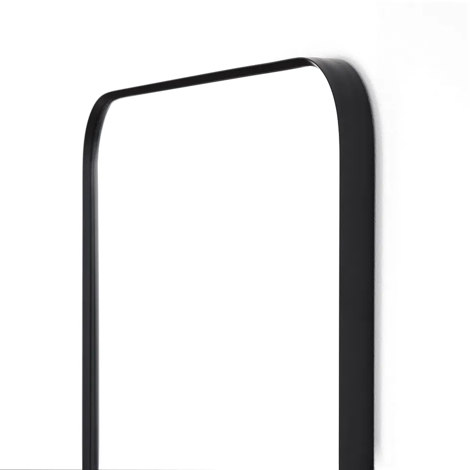 Black-framed mirror with rounded corners, high-quality finish, hangs vertically on a plain white wall.