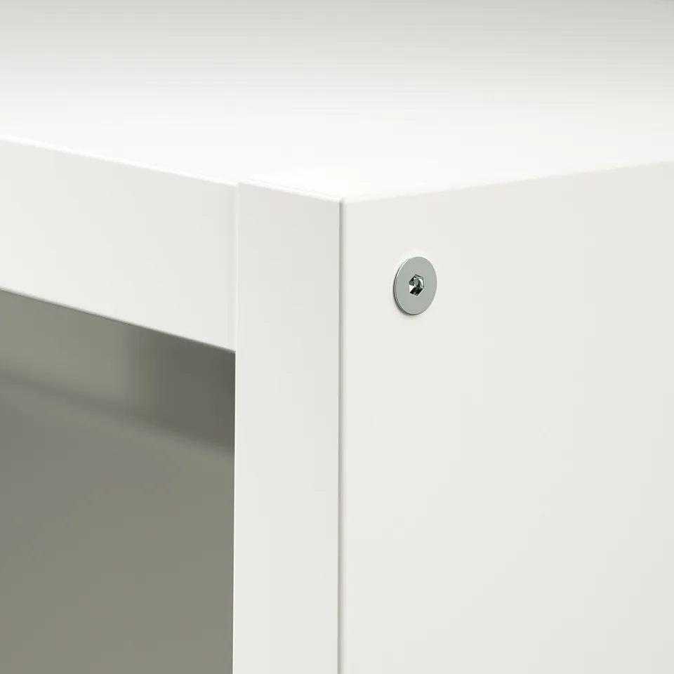 White cabinet corner with circular lock, reflecting surface.