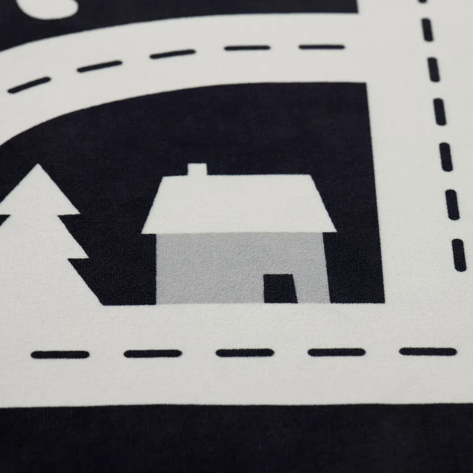 Black & white graphic rug detail, featuring house & trees, high quality materials.