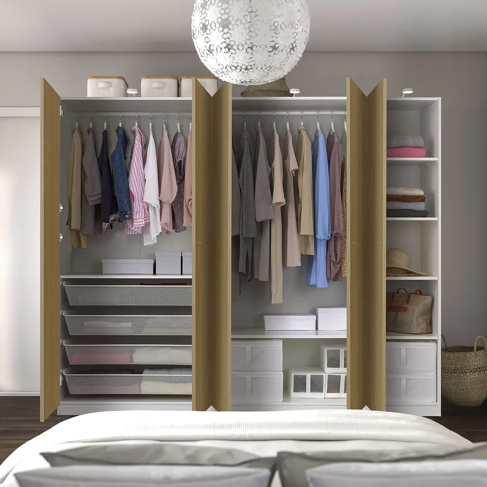 Modern wardrobe with clothes, shelves, drawers, and baskets. Sleek, adjustable, and airy. Light fixture included.