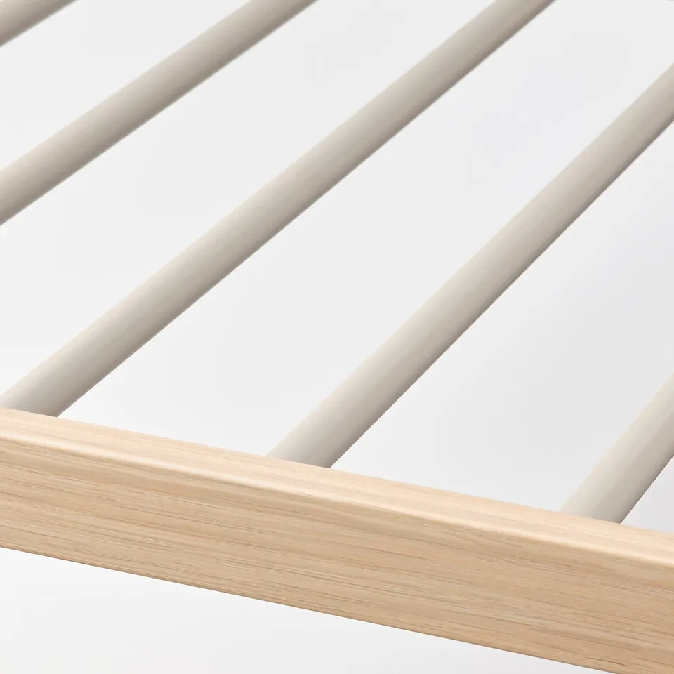 Close-up of sturdy, well-constructed trouser hanger. Light wood frame supports glossy bar rails for hanging pants.