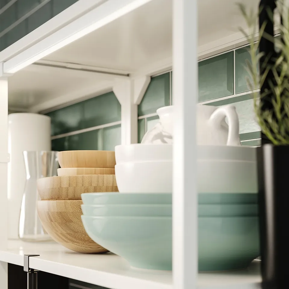 Kitchen shelf with nested bowls, vases, and planter. Wooden, woven, and ceramic, neatly stacked. Tall white vases, one with greenery. Modern design.