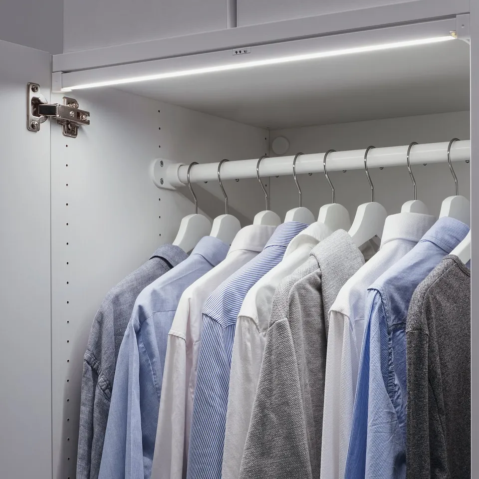 Closet with led light, illuminating clothes.