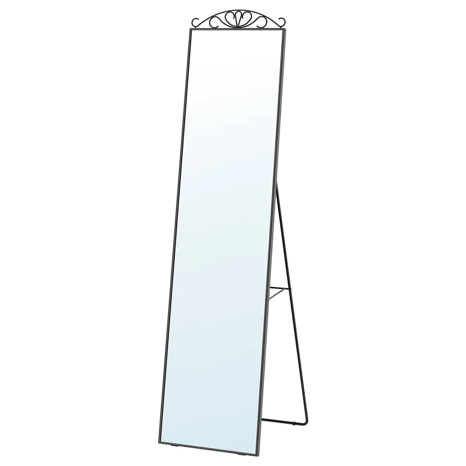 The KARMSUND mirror with a black frame and a decorative top. It is a full-length standing mirror with a sturdy metal base.