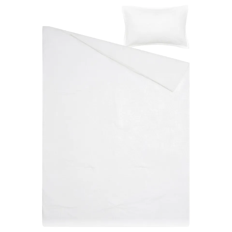 A white LUKTVICKER bedding set featuring a soft, breathable comforter with a waffle texture and matching pillow sham.