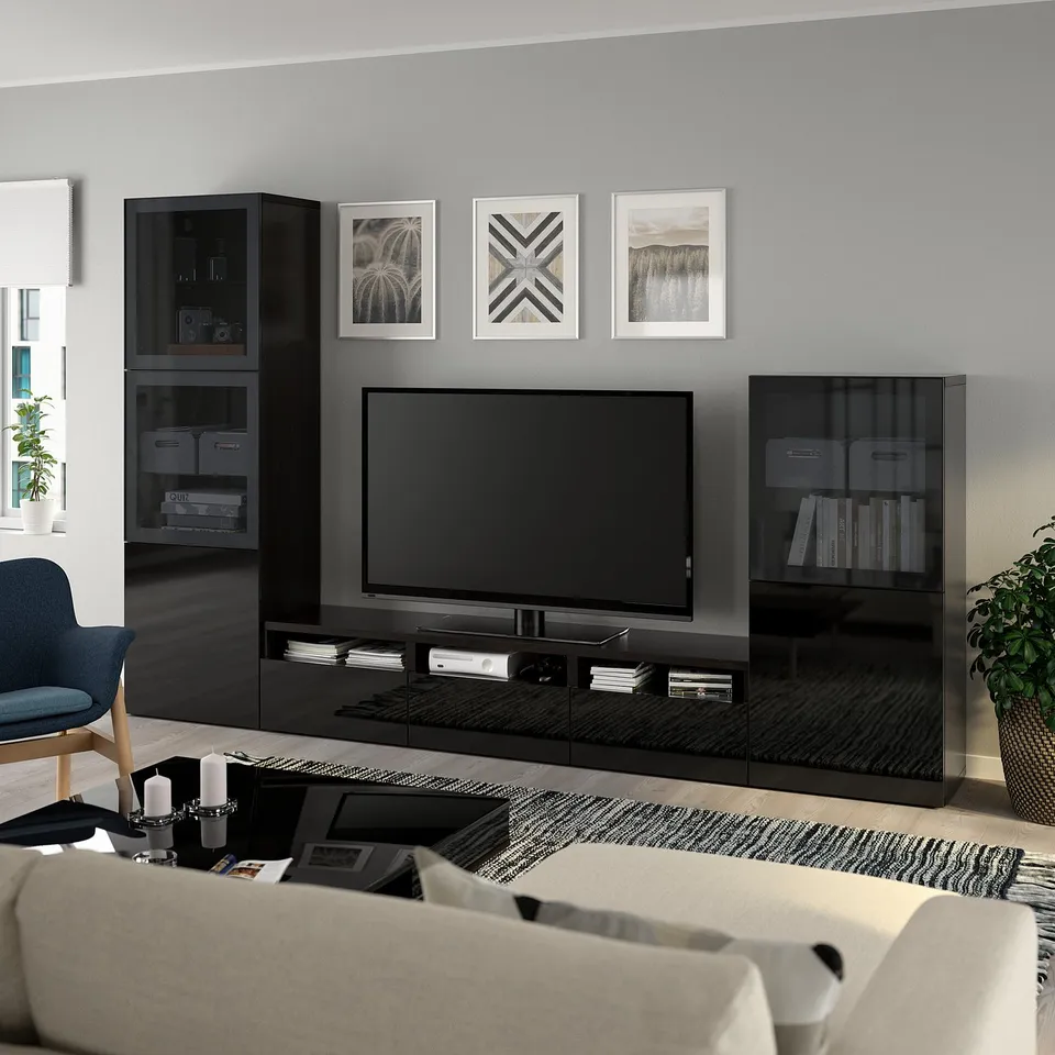 Modern living room with BESTÅ tv unit, shelves, couch, and decor. Artwork and plants included.