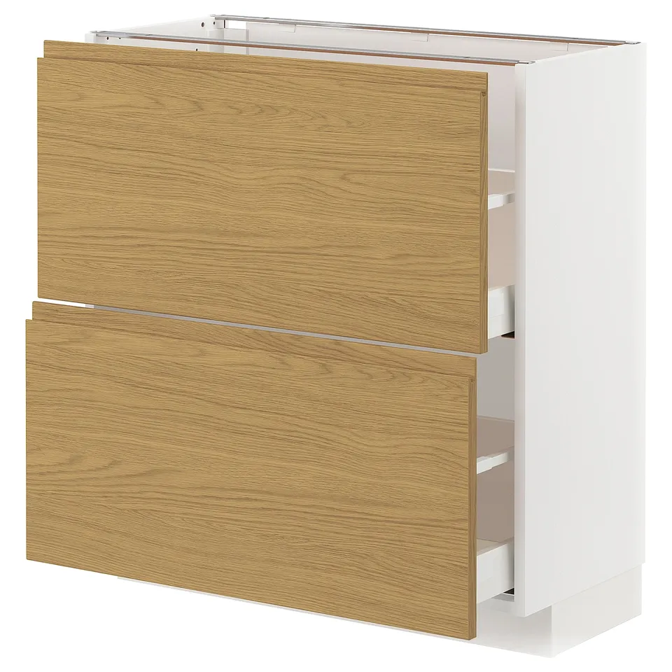METOD kitchen unit with oak-effect drawers and integrated handles. White with wooden grain texture, rectangular shape.