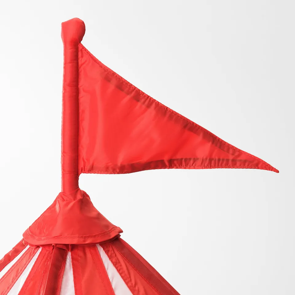 Play tent with bright red flag, sturdy structure, vibrant fabric. Fun, safe play area.