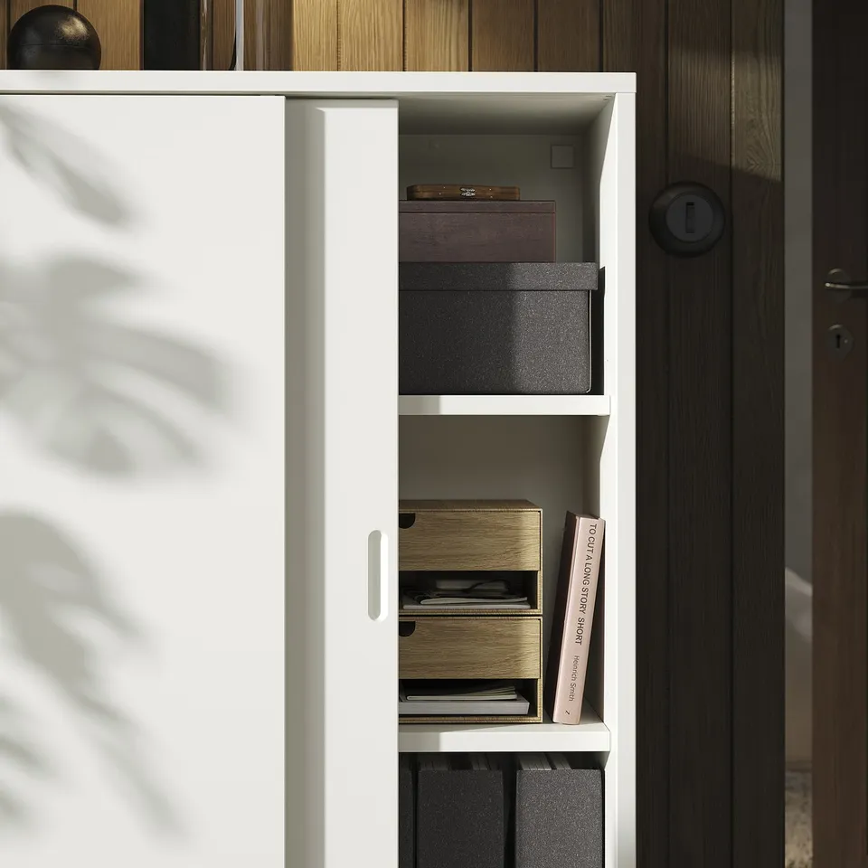 TONSTAD cabinet with sliding doors, boxes, books.