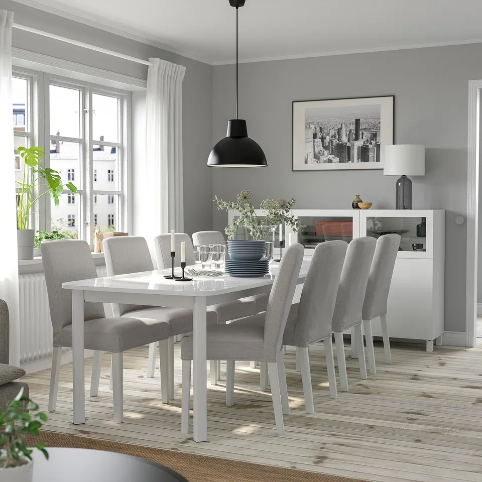 STRANDTORP white extendable dining set with 6 grey chairs around white table.