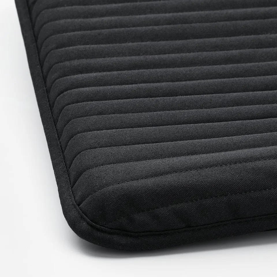 Black, plush cushioned seat with horizontal lines, likely from a POÄNG chair; soft and inviting.