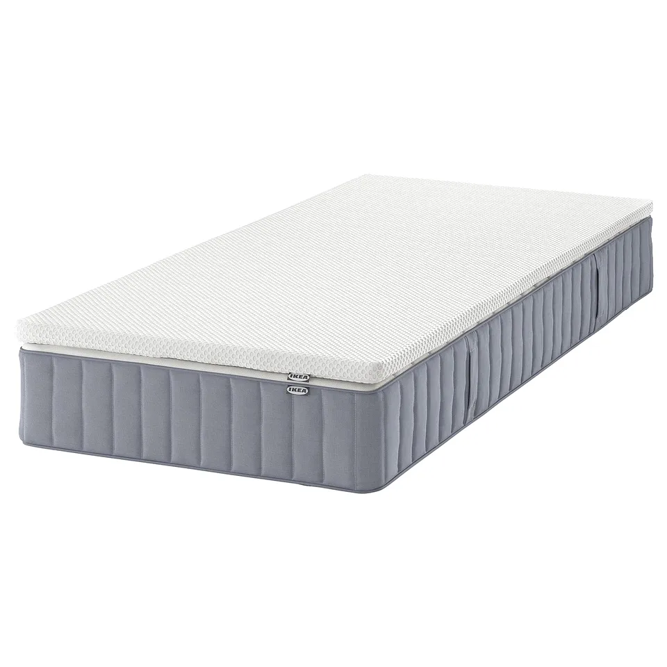 IKEA VALEVÅG mattress, white, rectangular, and upholstered with grey fabric.