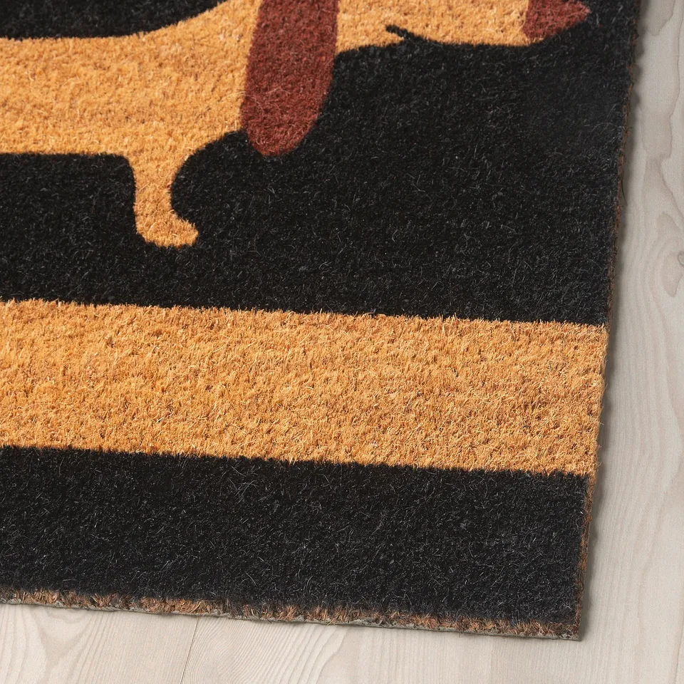 Dachshund-themed doormat with bold colours, made from eco-friendly coir.